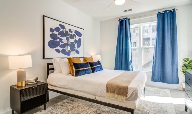 a bedroom with a bed and a lamp