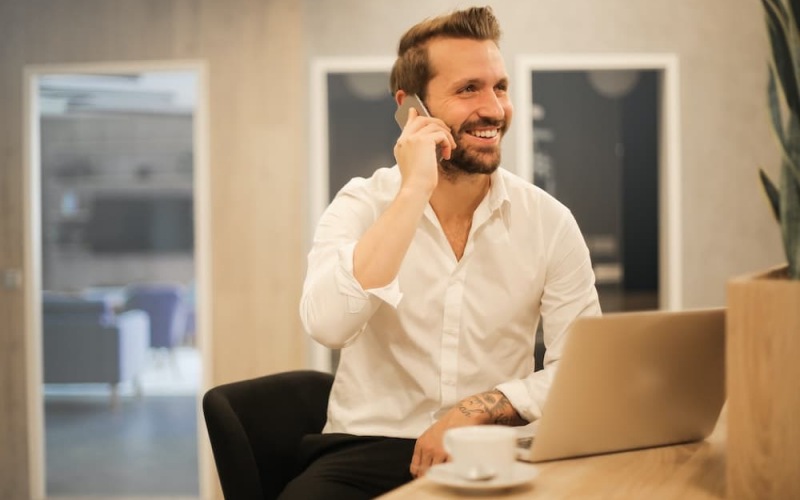 lifestyle image of a man smiling and talking on the phone