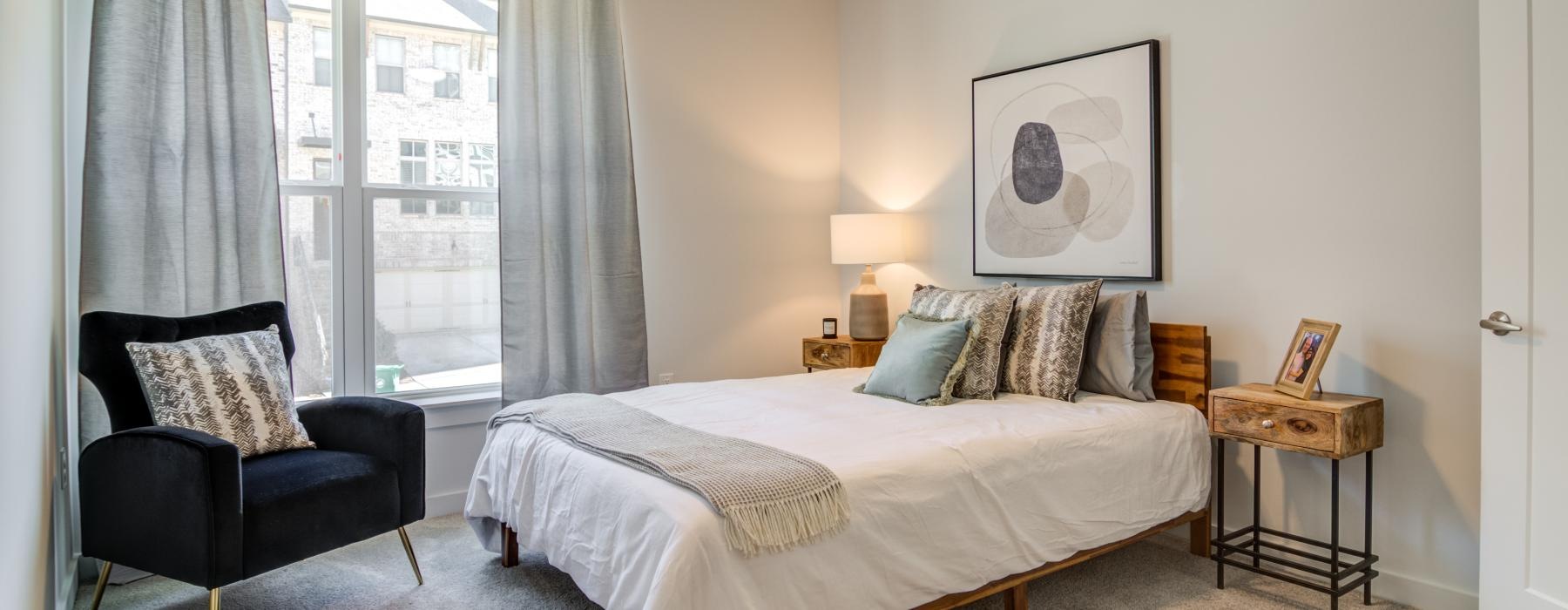 a bedroom with a bed and a chair